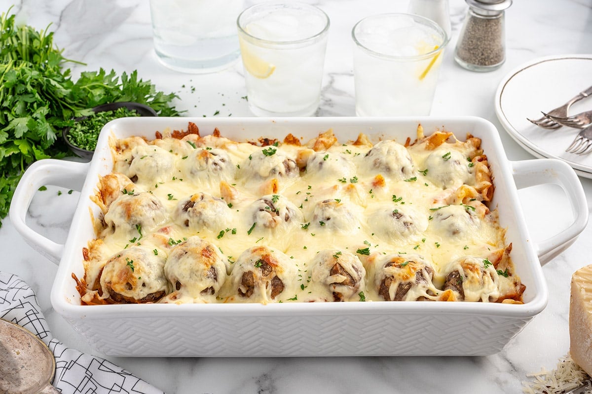 Meatball Casserole with melted cheese on a white table.