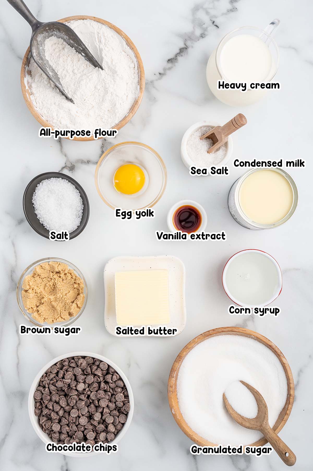 Millionaire Shortbread ingredients - flour, cream, sea salt, condesnsed milk, vanilla extract, egg yolk, salt corn syrup, butter, brown sugar, sugar and chocolate chips.