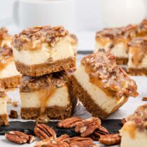 a couple of Pecan Pie Cheesecake Bars on a table.