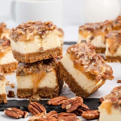 a couple of Pecan Pie Cheesecake Bars on a table.