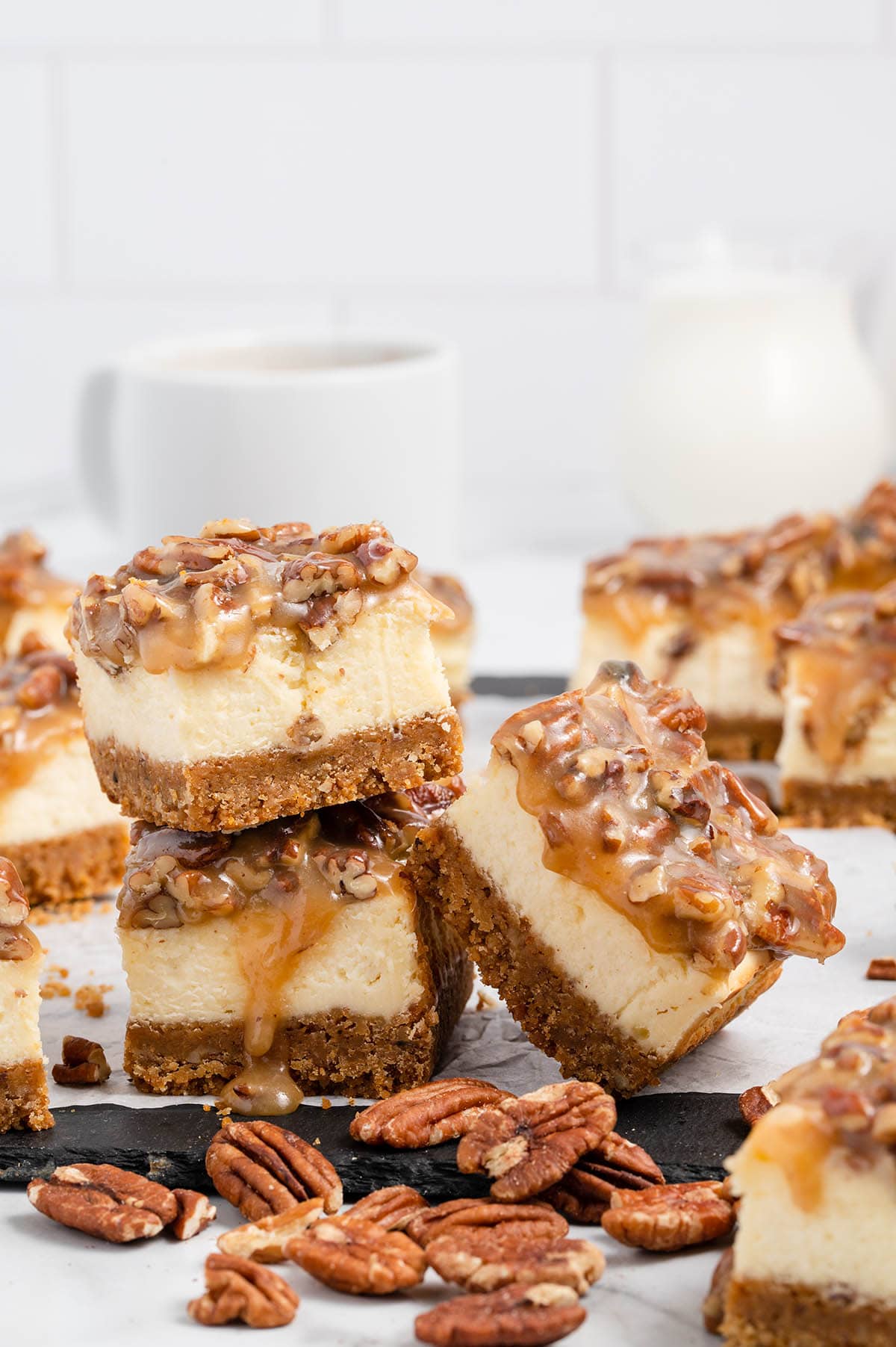 three Pecan Pie Cheesecake Bars with some toppings.