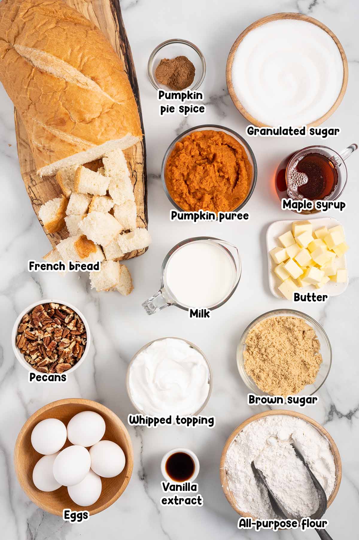 Pumpkin French Toast Casserole ingredients - french bread, pumpkin pie spice, sugar, syrup, pumpkin puree, butter, milk, pecans, whipped topping, brown sugar, eggs, vanilla extract, all purpose flour.