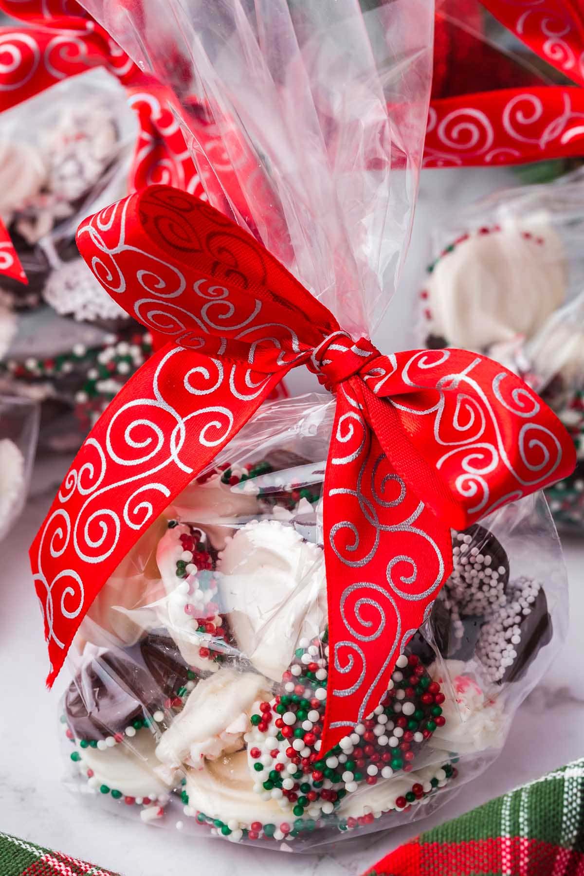 Chocolate Christmas Candy in a gift bag with red ribbon.