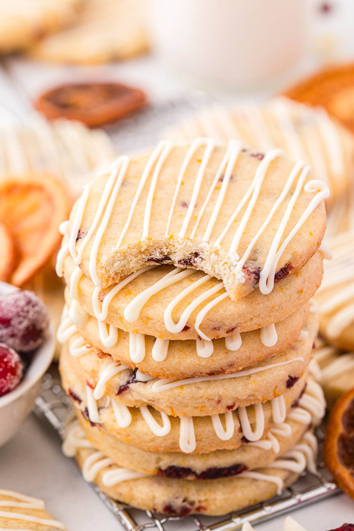a couple of Cranberry Orange Shortbread Cookies stacked on top of cooling rack.
