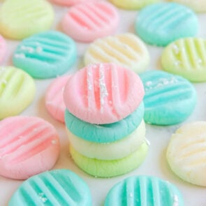 pink, blue, white and green cheese mints stacked on top of each other.