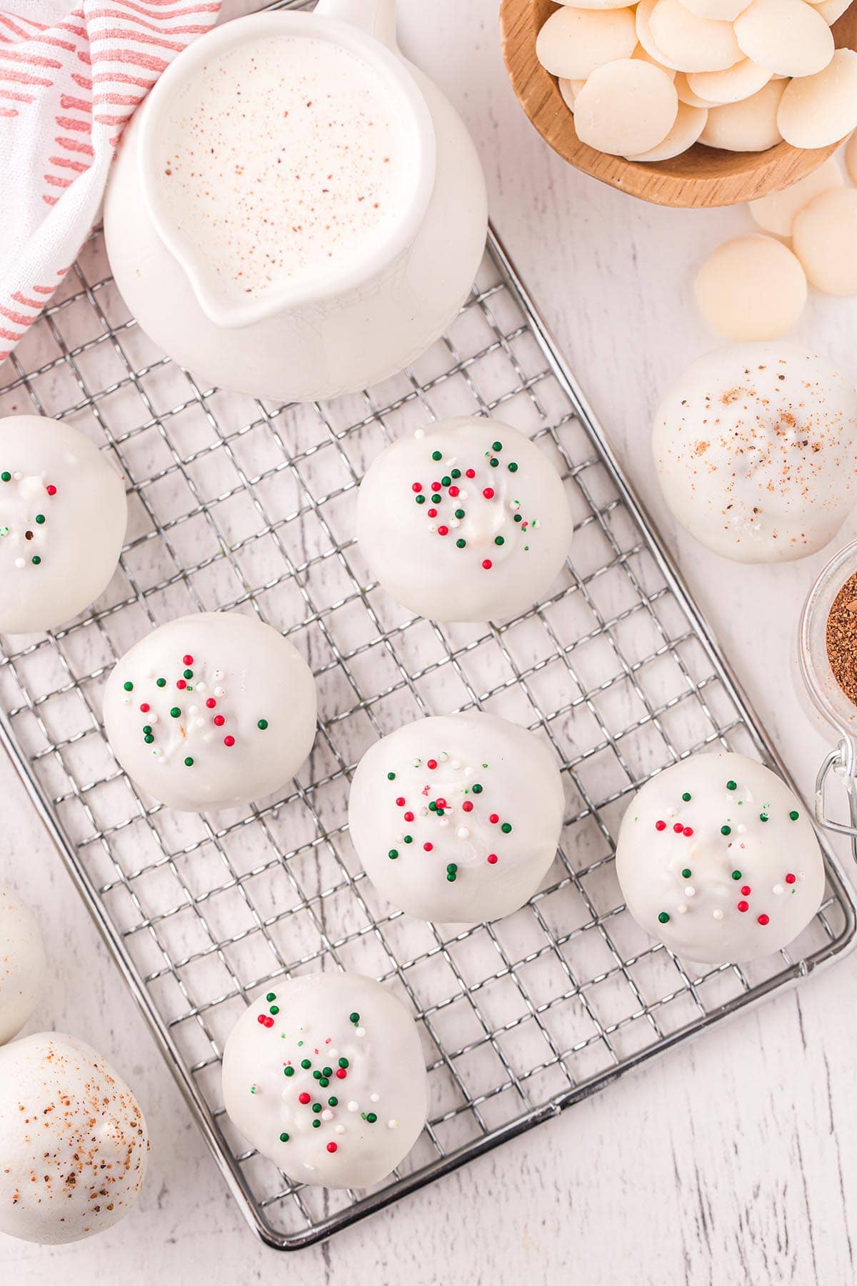 a couple of Eggnog Cake Bites with red, blue and white sprinkles on cooling rack.