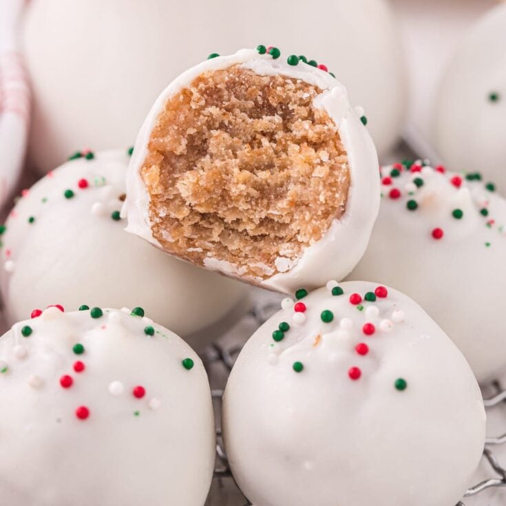 bitten Eggnog Cake Bites with a couple others on a white table.
