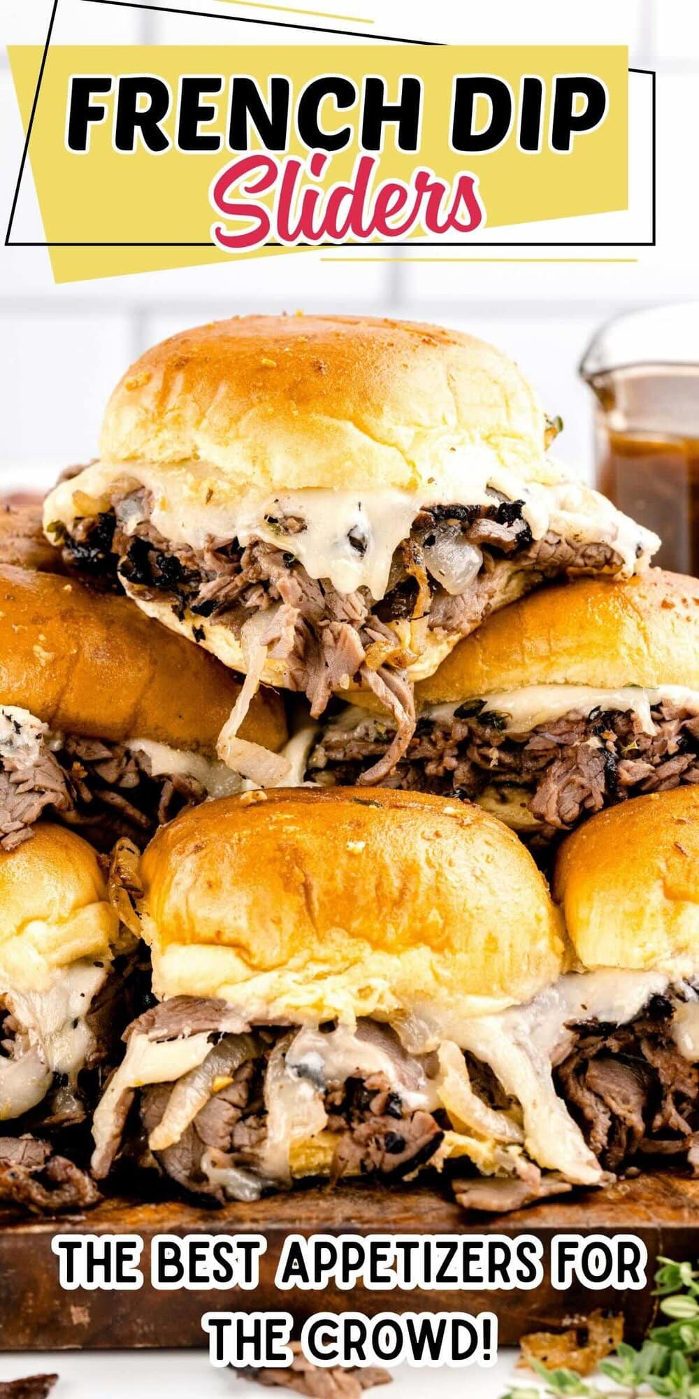 A pile of Baked French dip sliders made with tender roast beef and melted cheese.