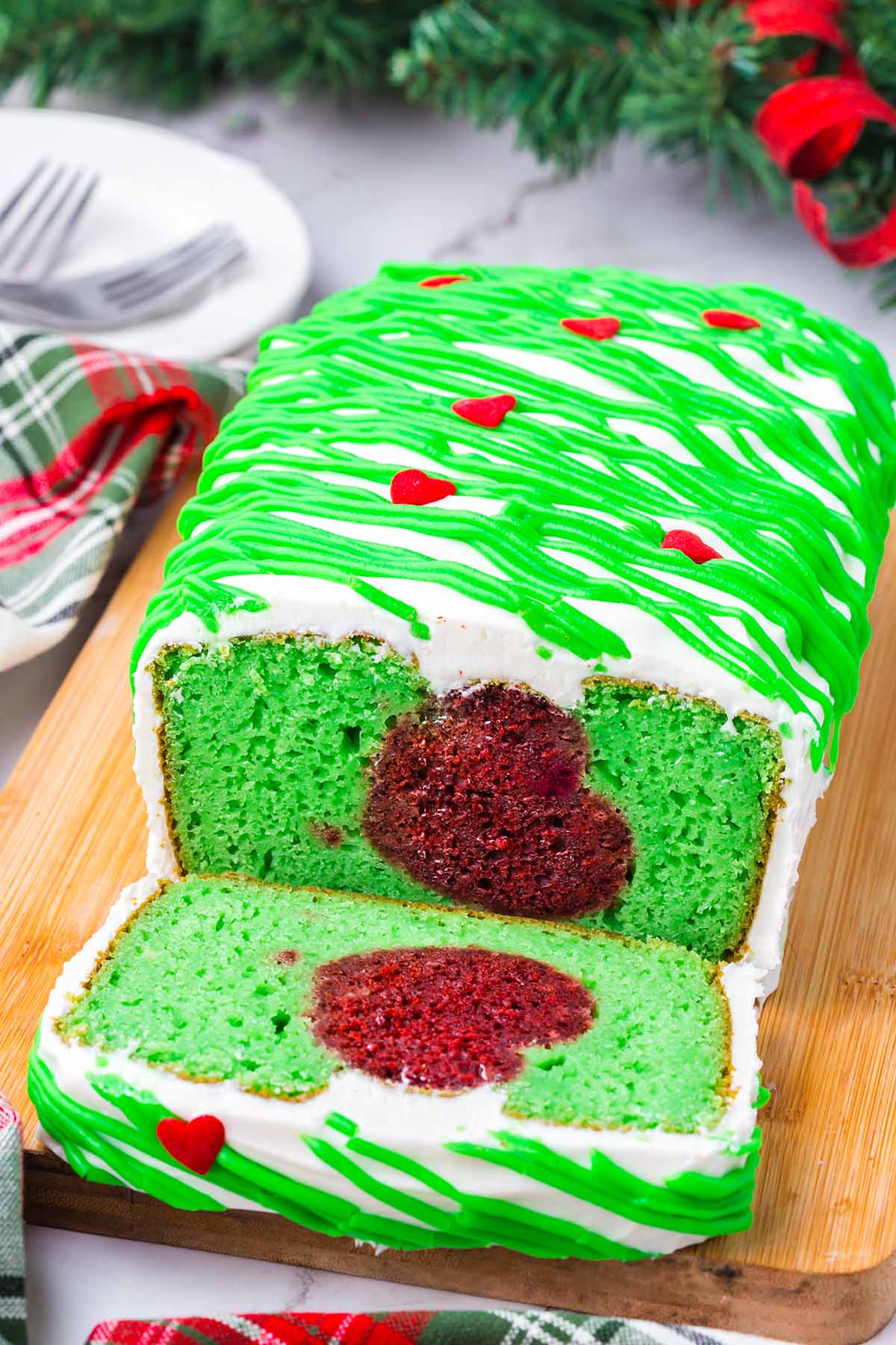 a loaf of grinch cake with heart shaped pattern on the inside. 