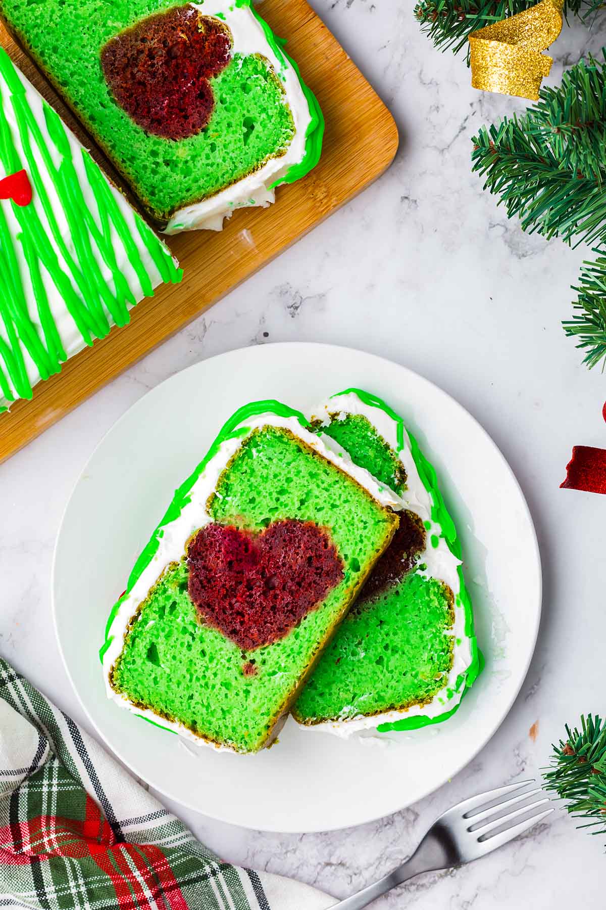 2 slices of Grinch Cake on a white plate.