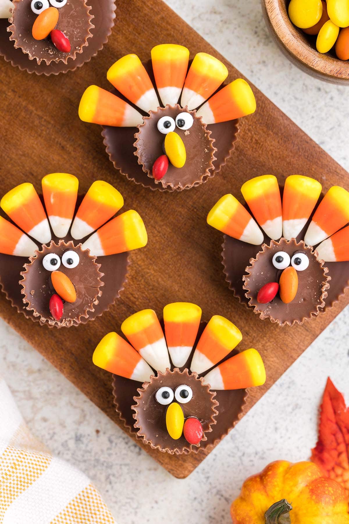 a couple candy turkey on top of wooden board. 