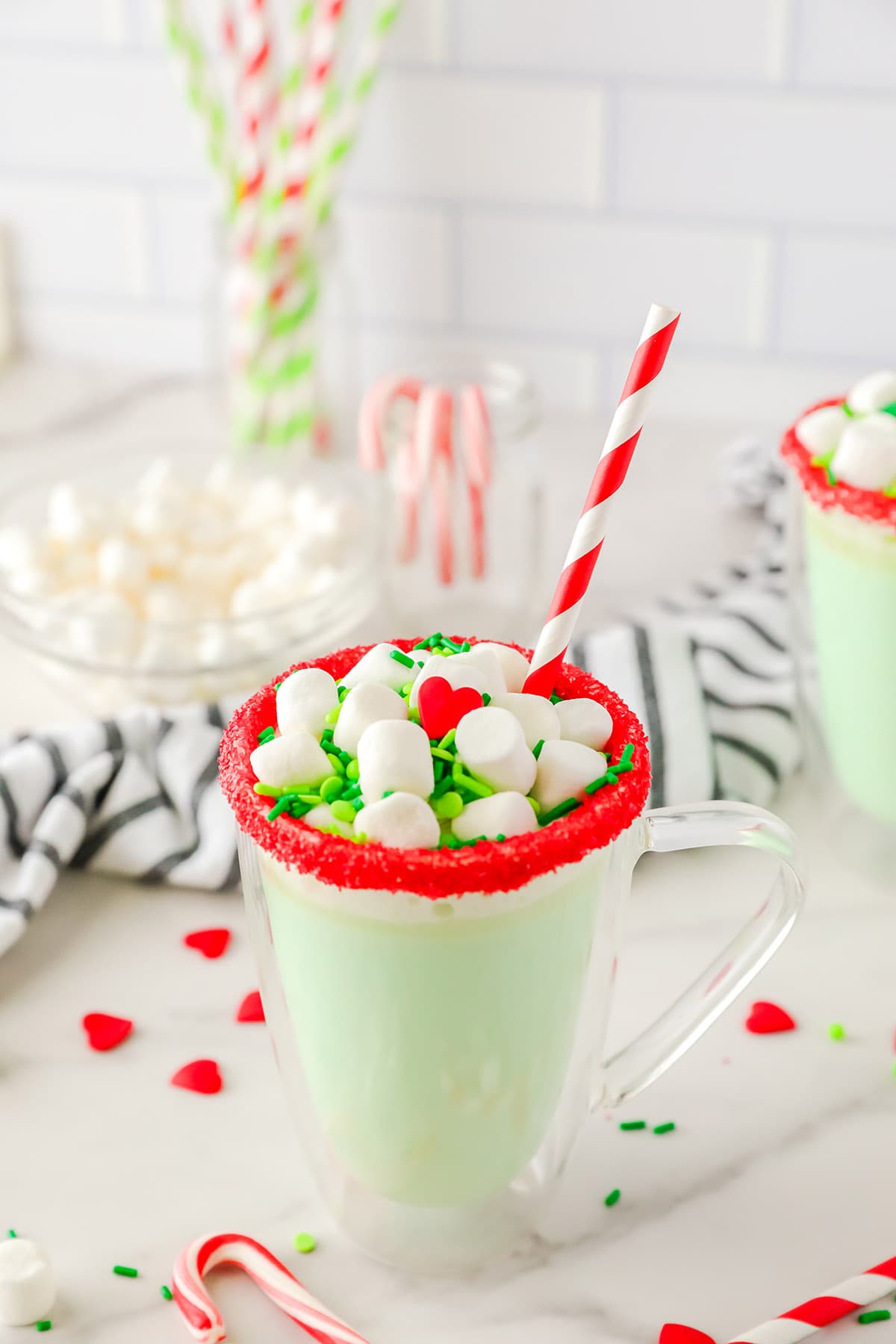 Slow Cooker Grinch Hot Chocolate in a glass mug with marshmallows on top.