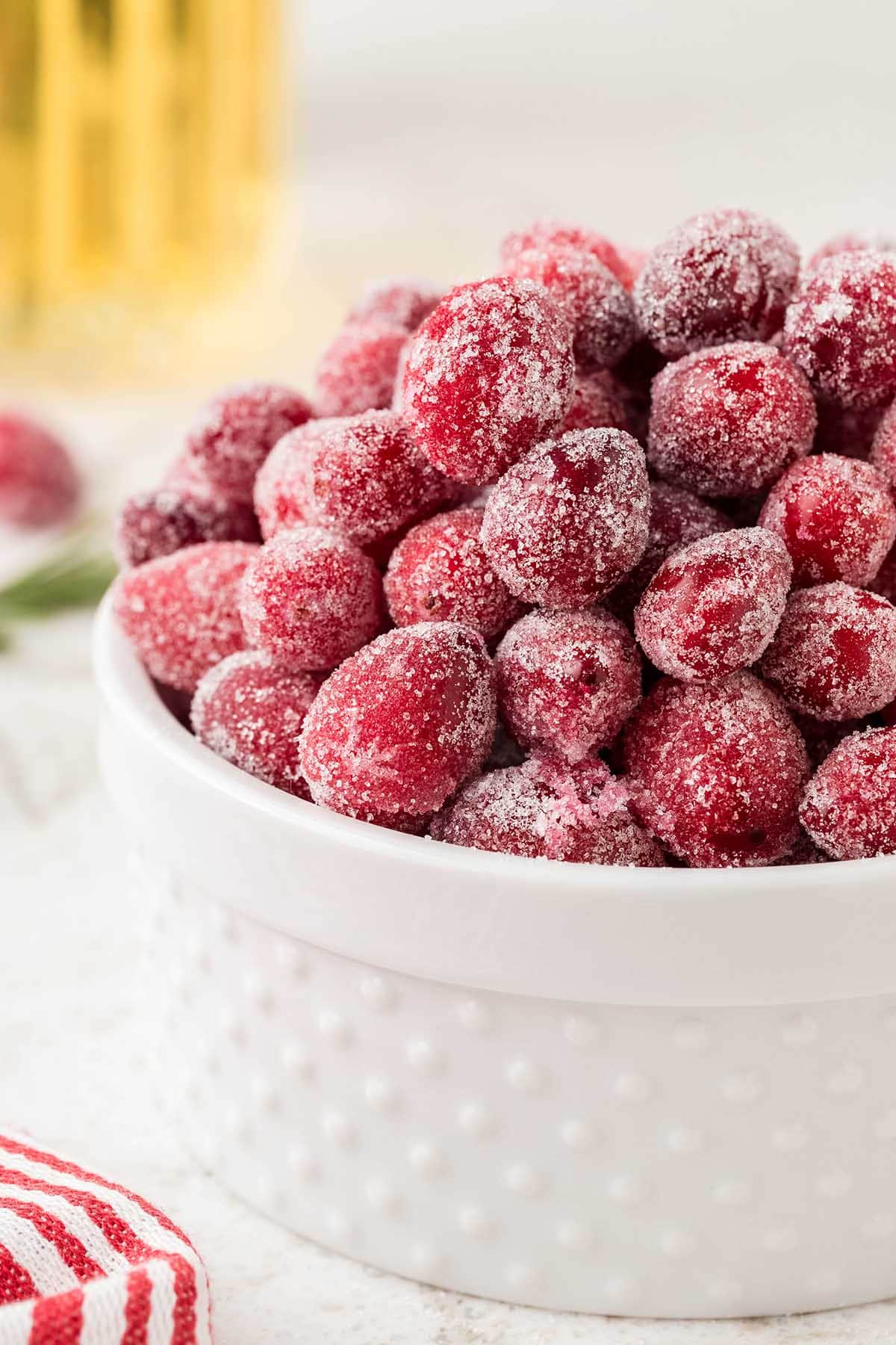 sugared cranberries in a white bowl.