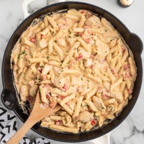 Cajun Chicken Pasta in a skillet on a white table.