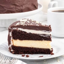 Chocolate Layer Cheesecake with Cream Cheese Filling sliced on a white plate.