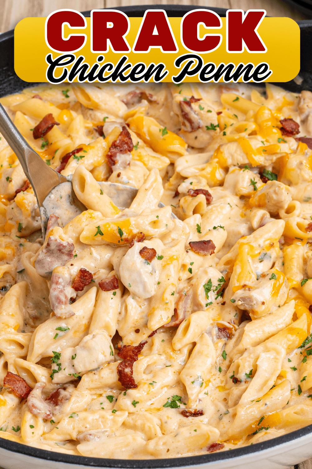 Crack chicken penne served on a dark plate and being spooned from a skillet with cheddar and bacon.