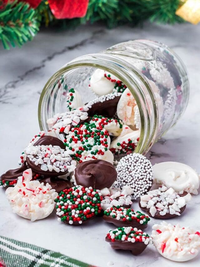 Chocolate Christmas Candy scattered on a white table.
