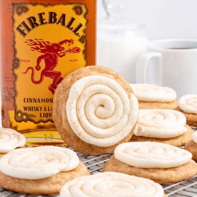 Fireball Cookies on a cooling rack with cream cheese on top.