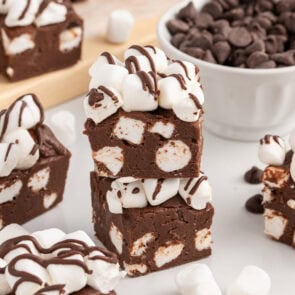 Hot chocolate fudge squares with marshmallows and chocolate drizzle.