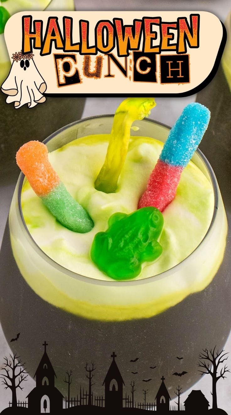 Green Halloween Punch decorated with gummy worms served in a glass