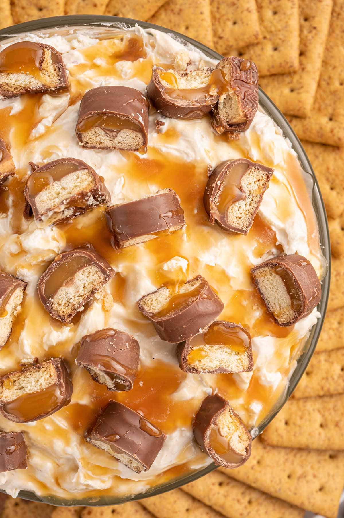 Twix Dip drizzle with caramel sauce and candy bar.