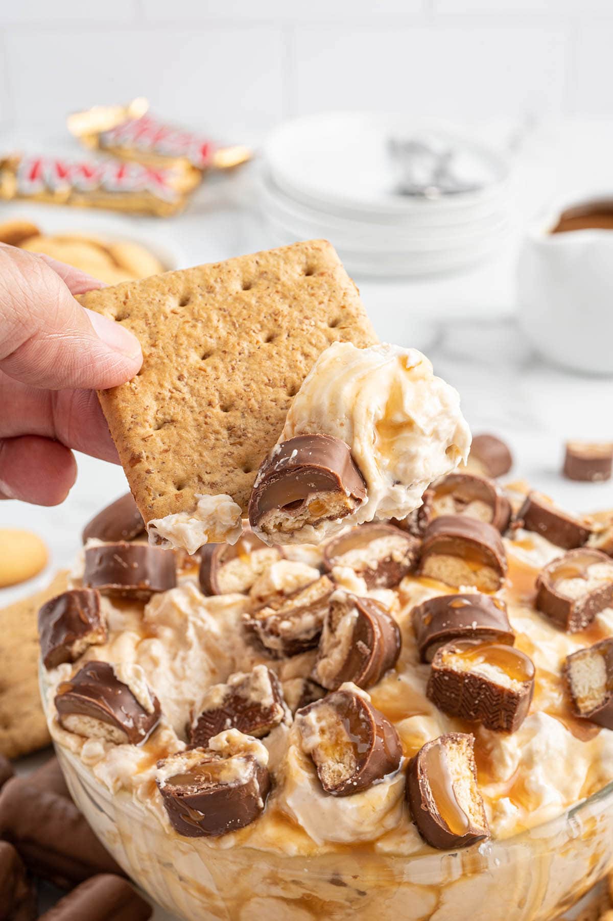 dipping crackers into the twix dip.