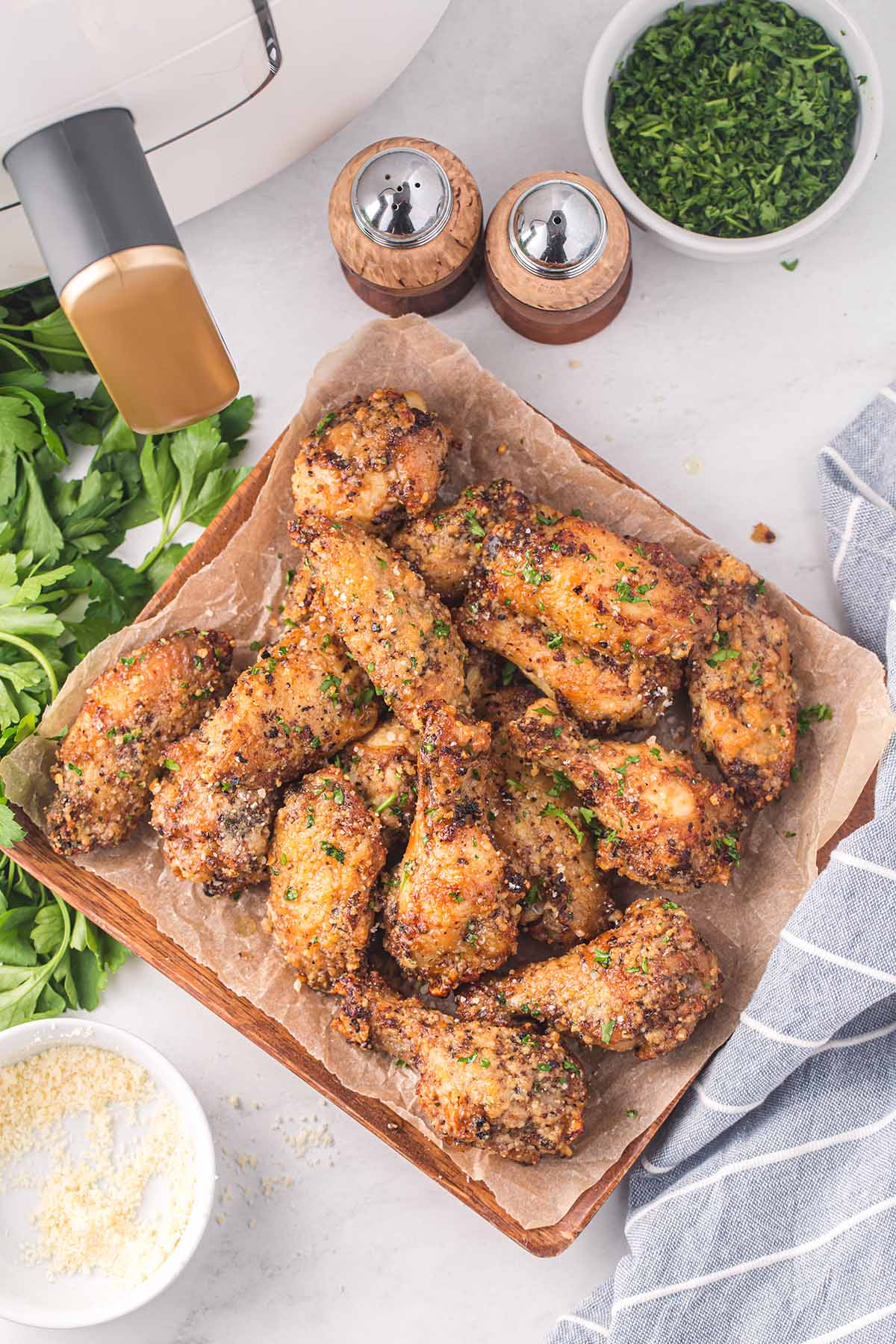 a couple of Air Fryer Parmesan Garlic Chicken Wings on the table.