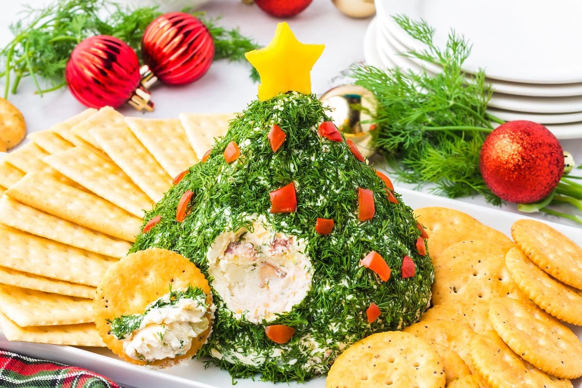 Cracker dipped into Christmas Tree Cheese Ball.