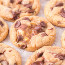 Snickers Cookies on top of parchment paper.