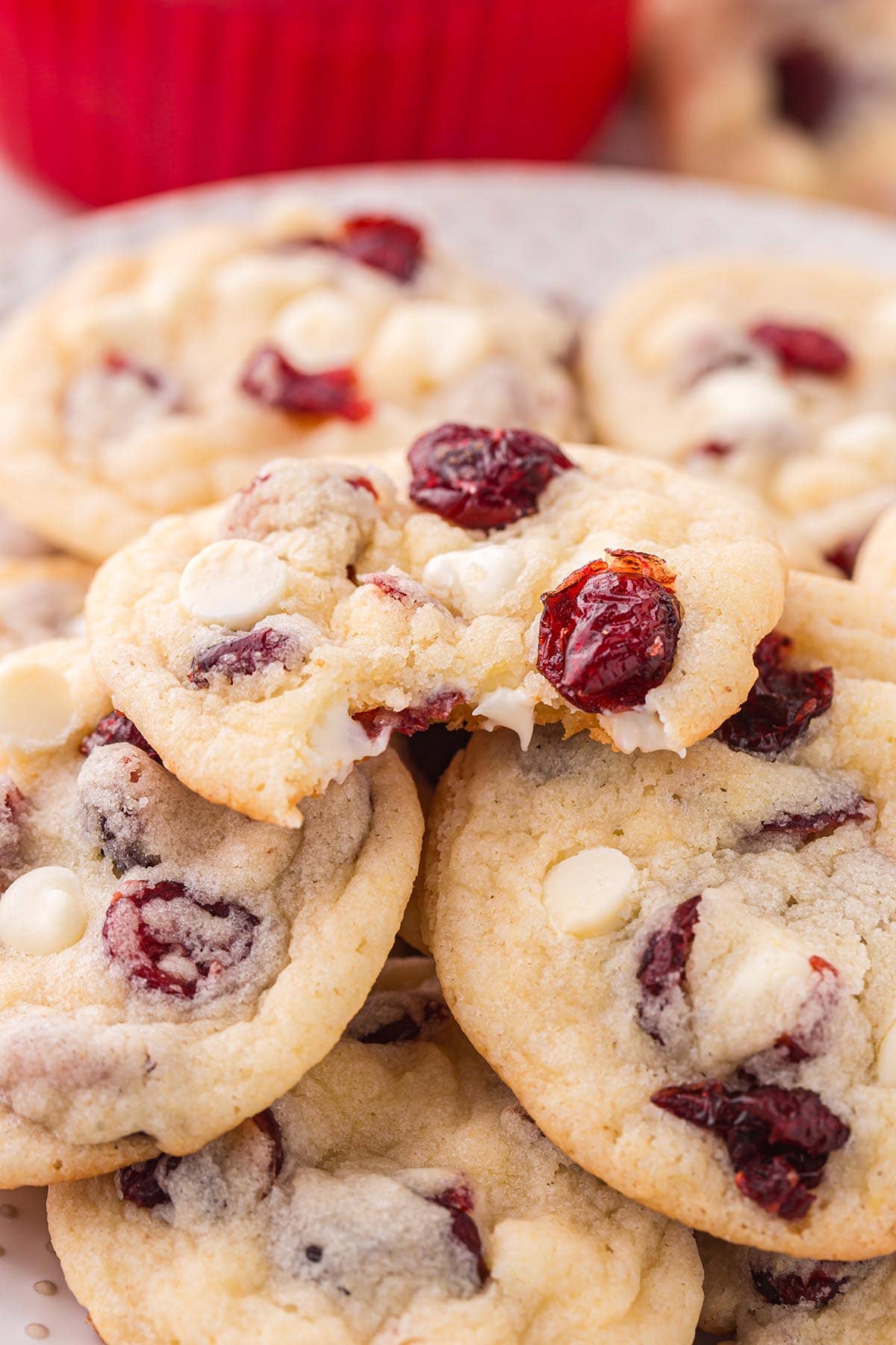 a couple of white chocolate cranberry cookies on a plate.