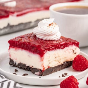 a slice of Chocolate Raspberry Cheesecake Delight with whipped topping.
