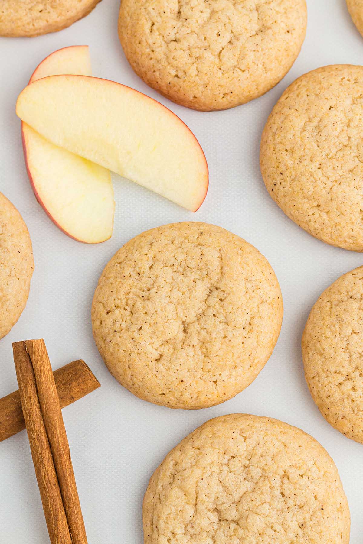 Applesauce Cookies on the table with a couple slices of apple.