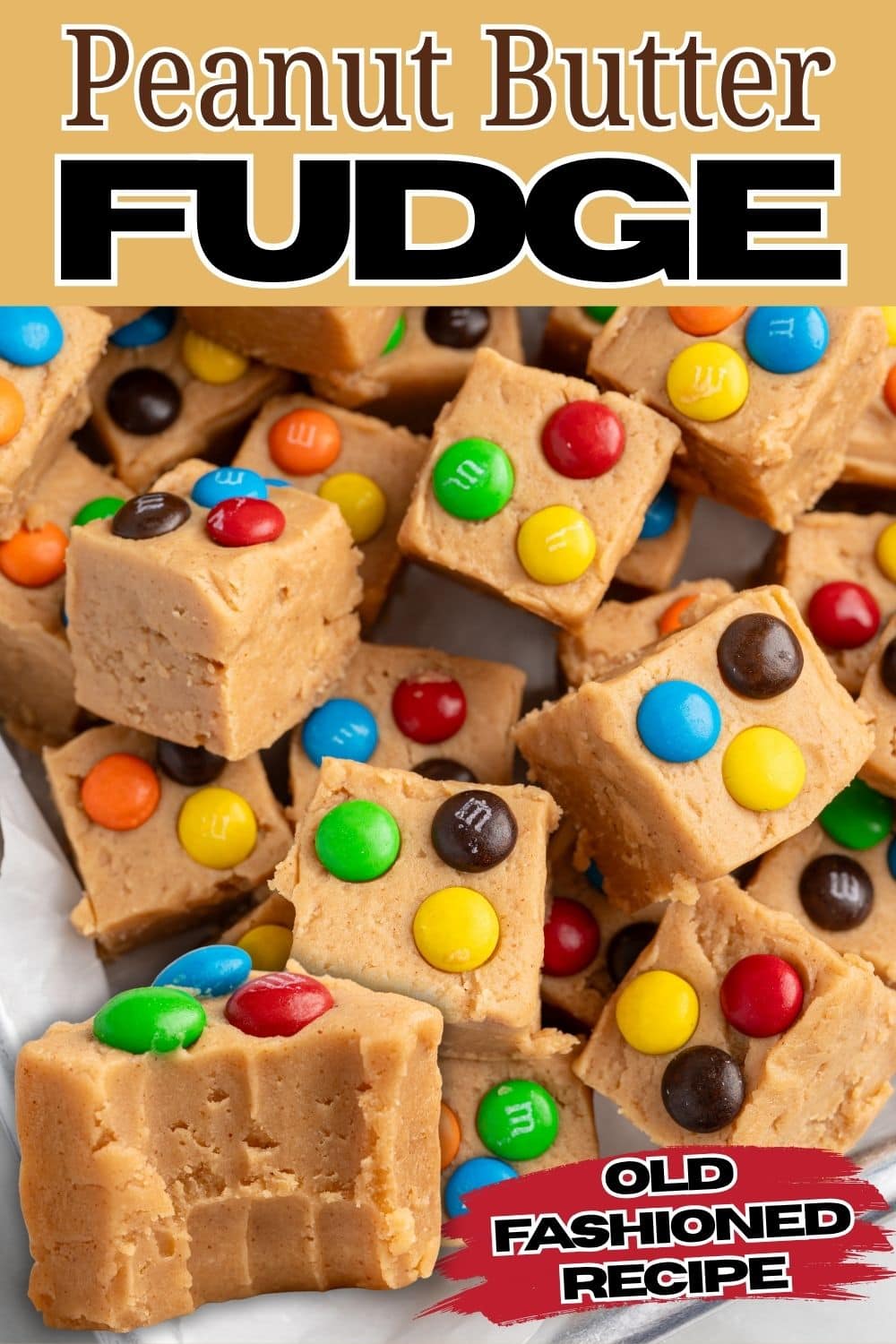 Old fashioned peanut butter fudge squares topped with colorful candy pieces.