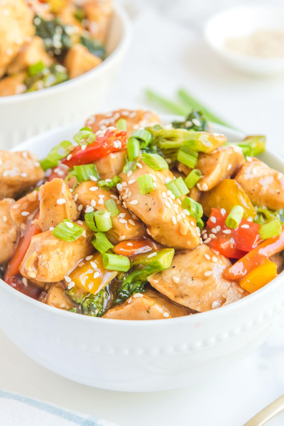 stir fry chicken served with rice in a bowl.