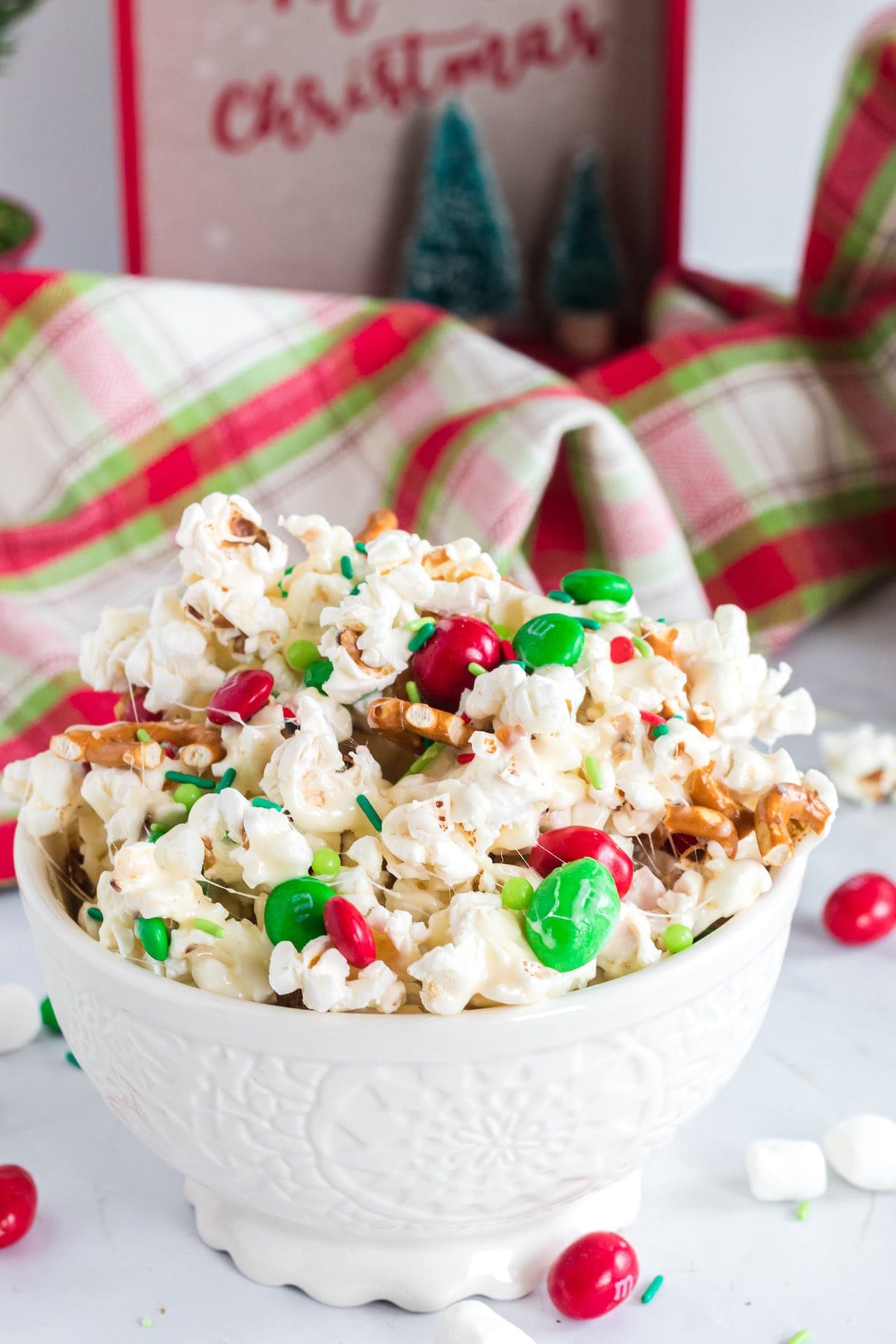 christmas crunch in a bowl with christmas greeting card in the background.