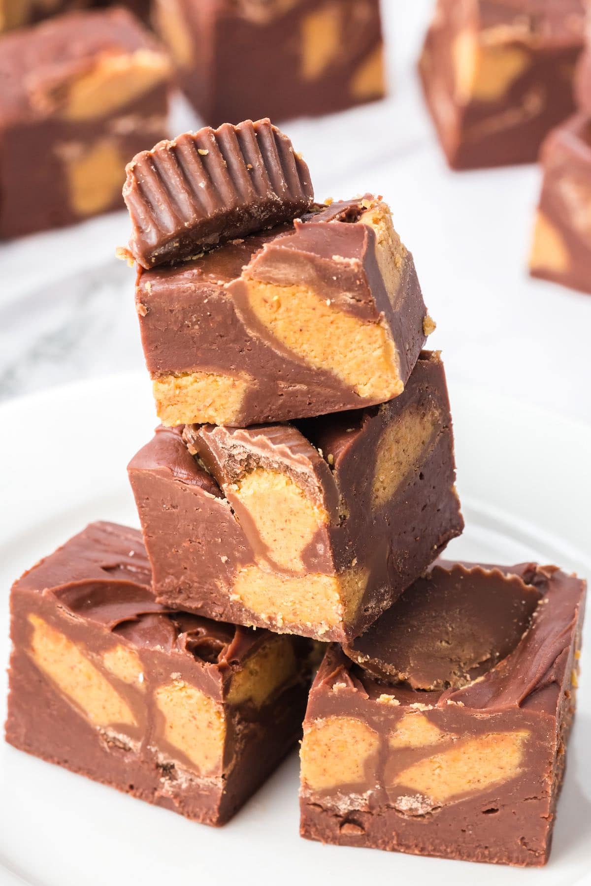 Easy Reeses Fudge stacked up on a plate.