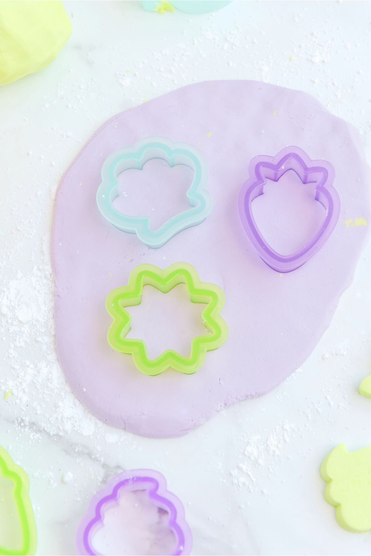 playdough flatten and cut into different shapes with cookie cutter.