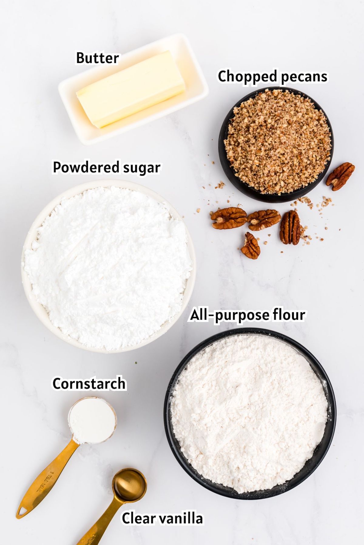 snowball cookies ingredients including flour, cornstarch, vanilla, powdered sugar, chopped pecans and butter