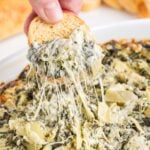 bread dipped in spinach artichoke dip.