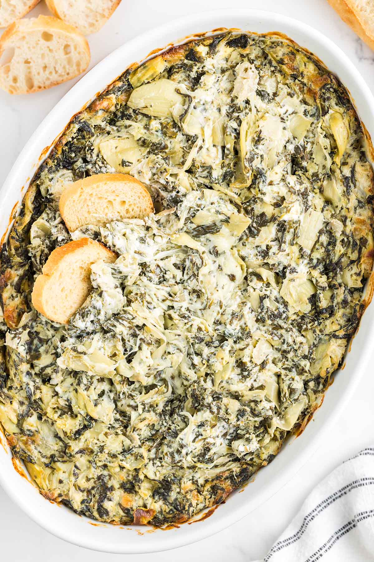 spinach artichoke dip with 2 slices of bread.