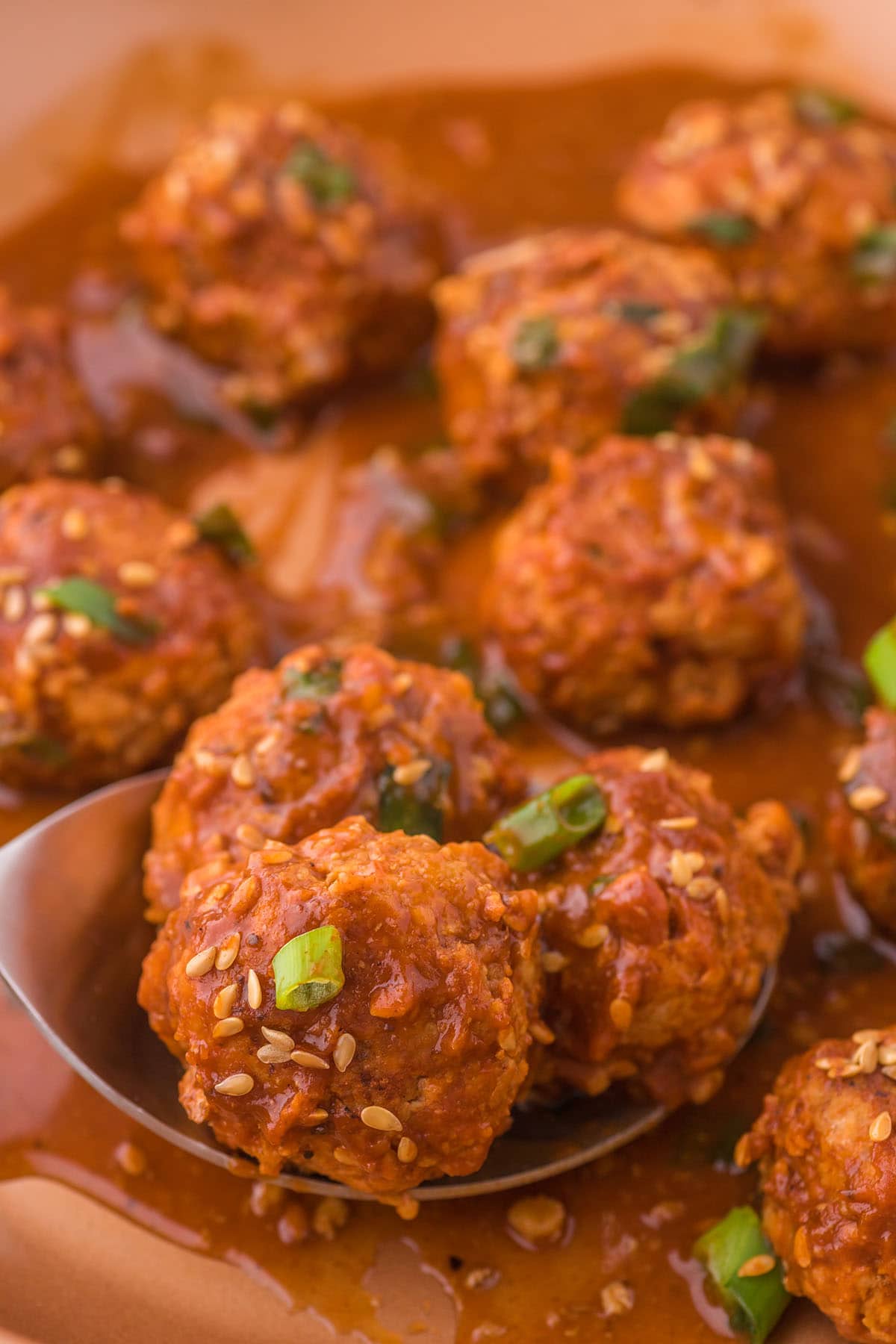 Asian Meatballs scooped using a spoon.