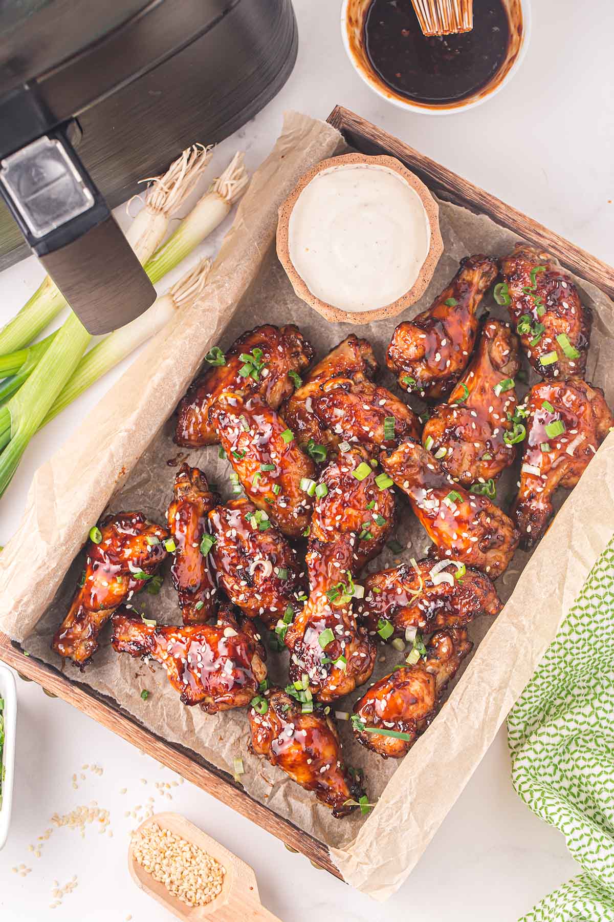 Air Fryer Asian Sticky Wings served inside wooden tray.
