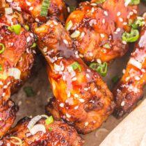 Air Fryer Asian Sticky Wings garnished with sesame seeds and spring onions.