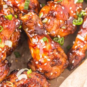 Air Fryer Asian Sticky Wings garnished with sesame seeds and spring onions.