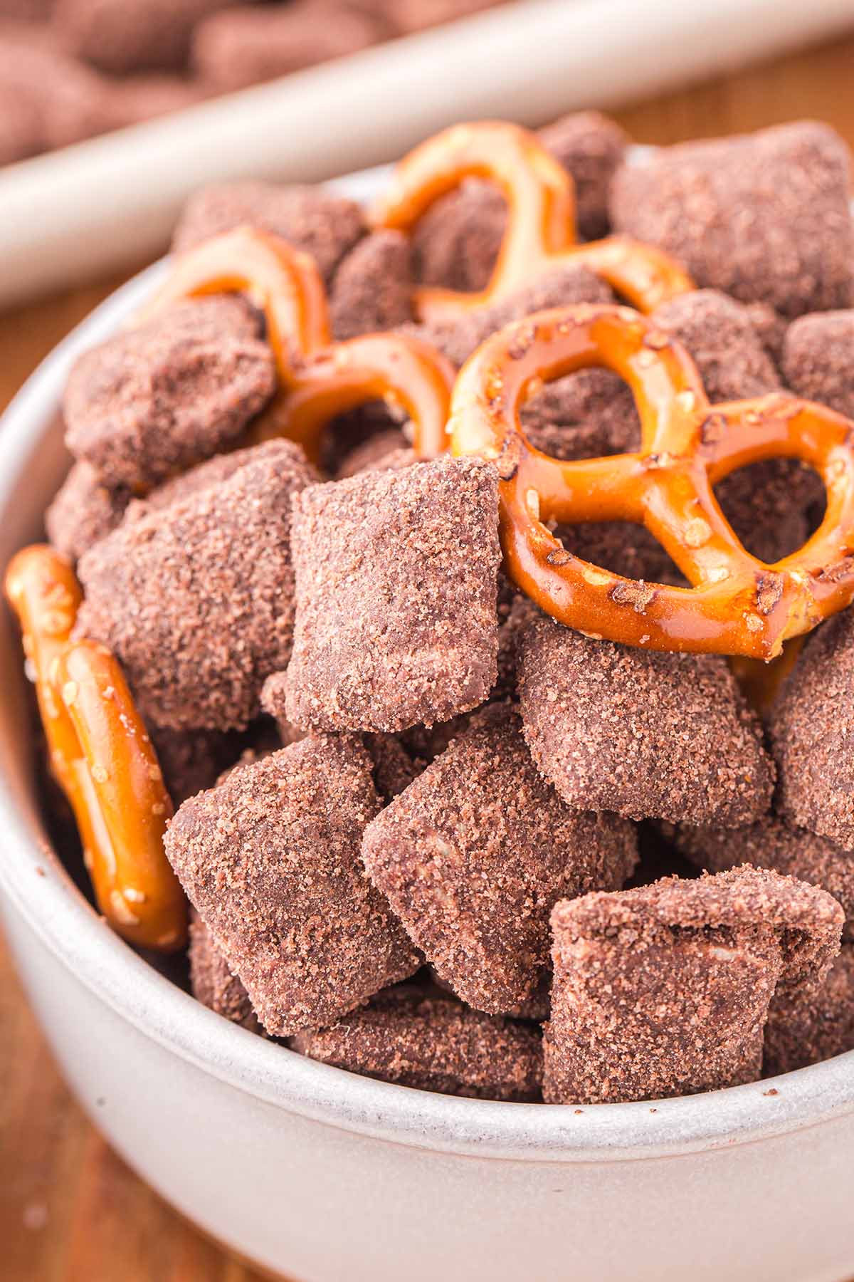 Brownie Batter Puppy Chow with pretzels in a bowl.