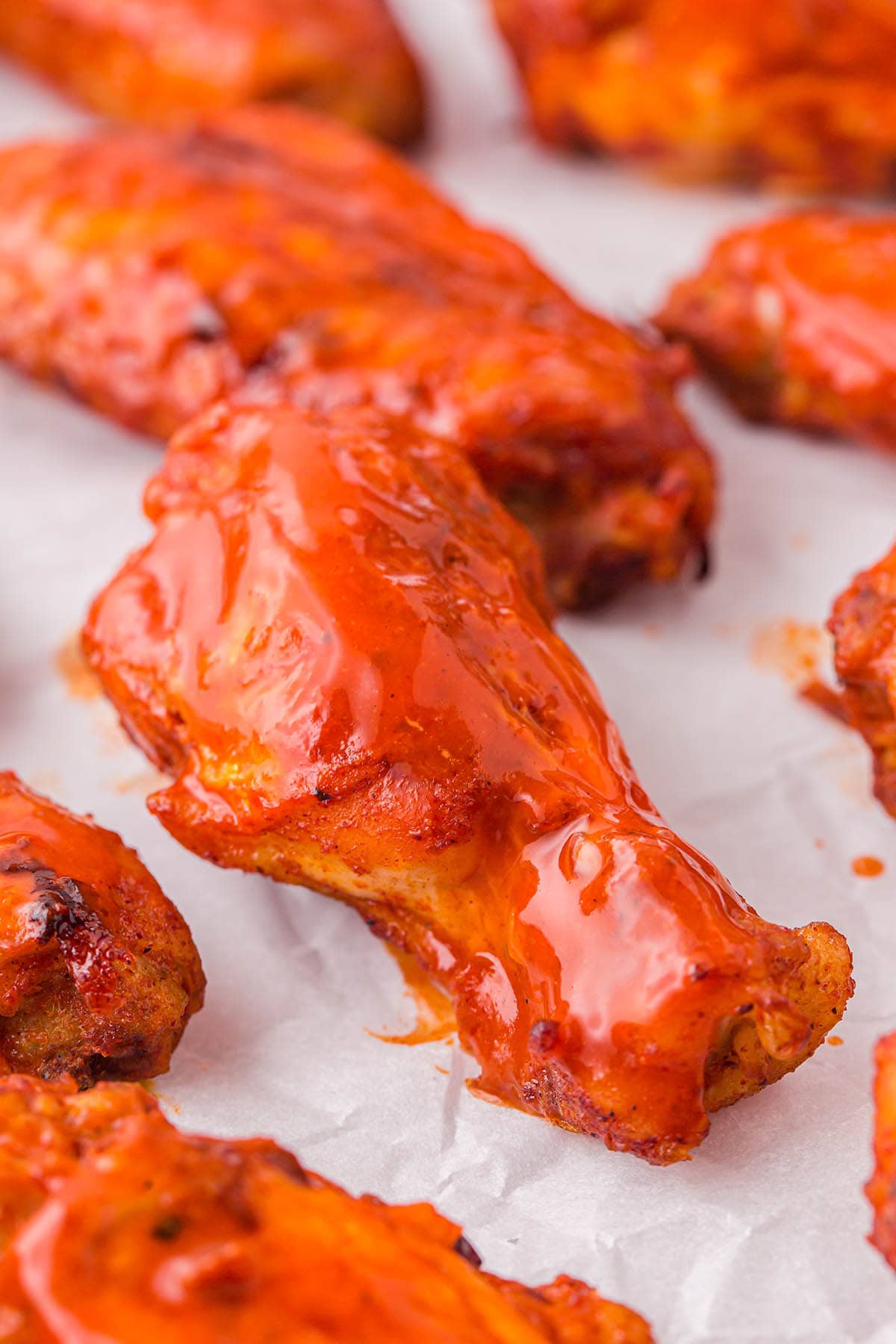 Instant Pot Buffalo Wings on top of parchment paper.