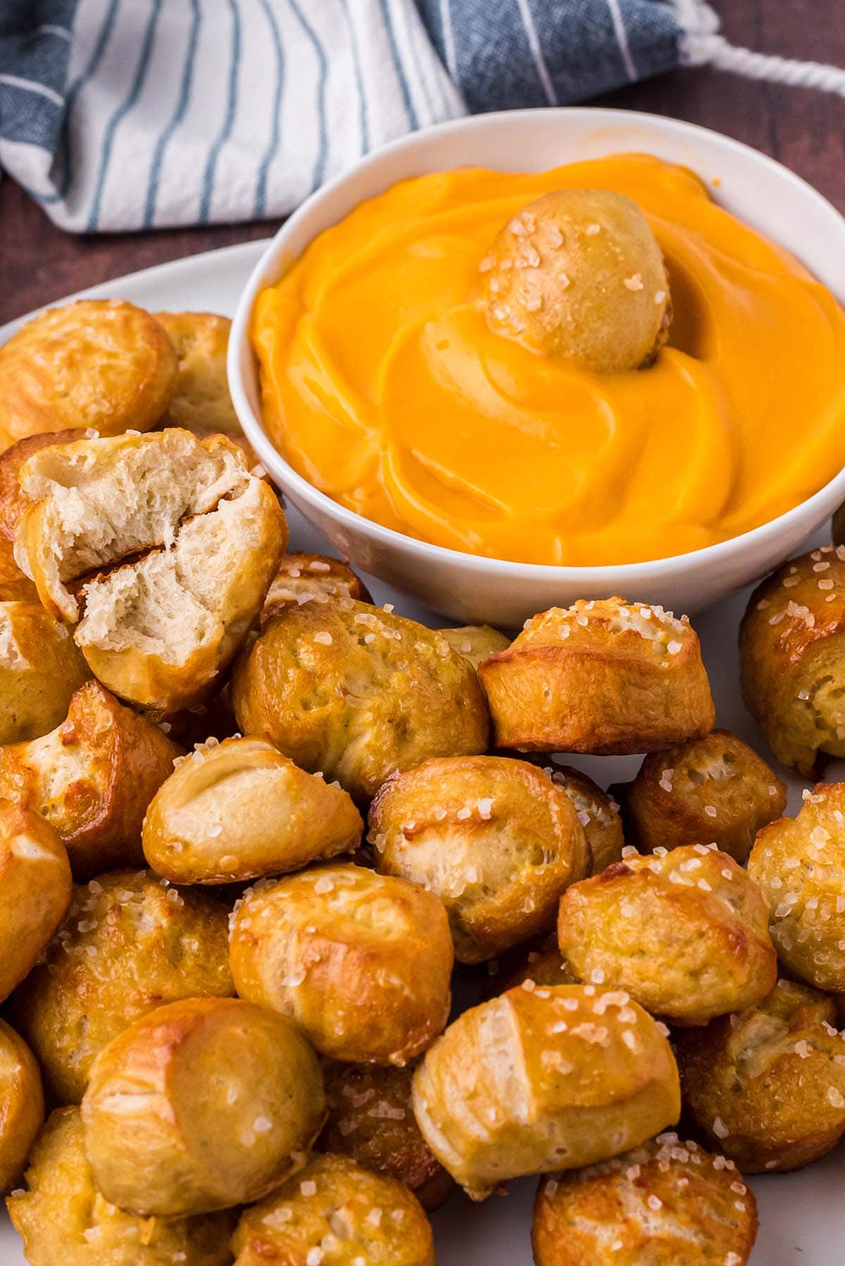 Soft Pretzel Bites dipped in cheese sauce.