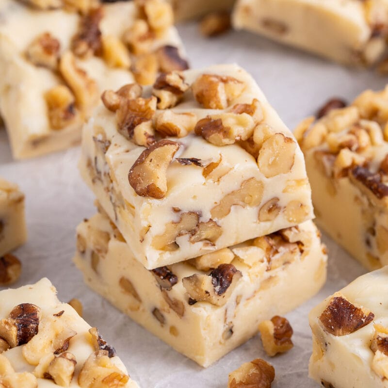 a couple of Maple Walnut Fudge over parchment paper.