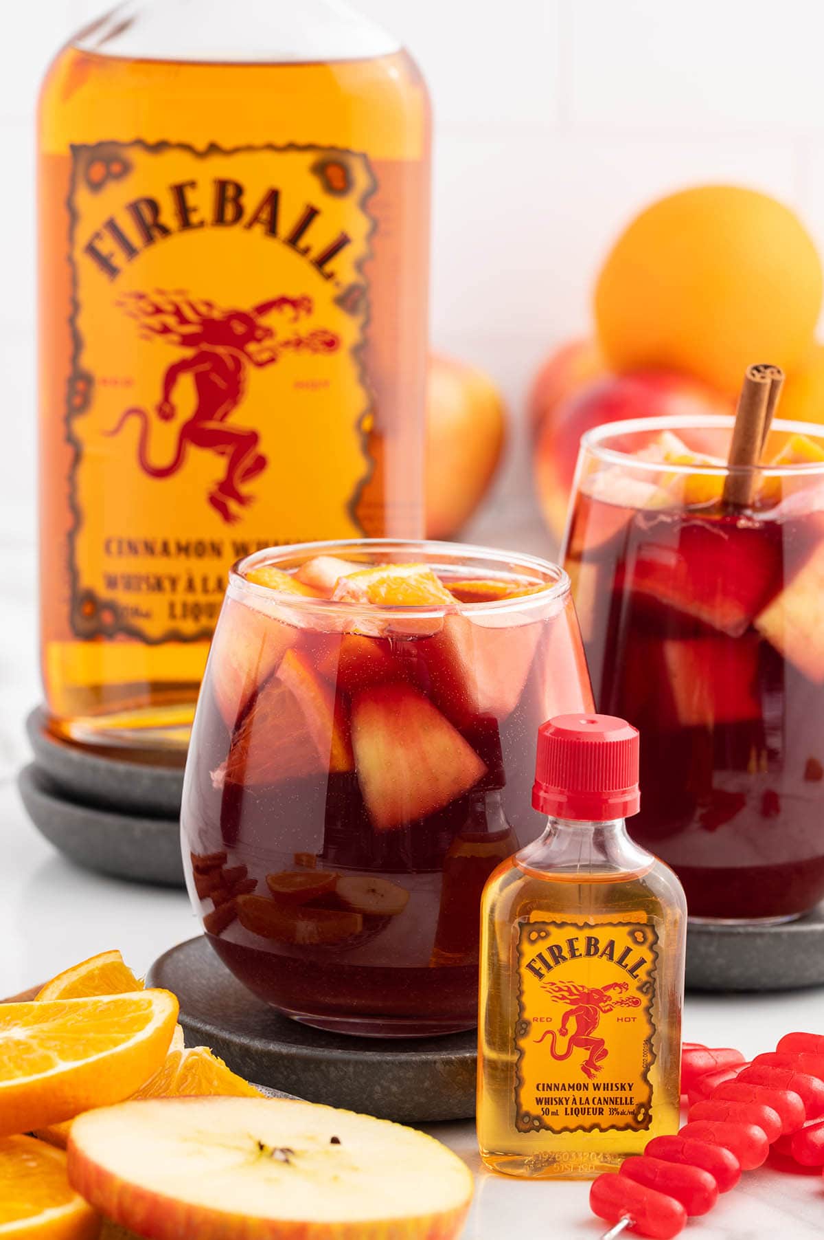 Fireball Sangria in a glass with a bottle of fireball whisky on the side.