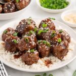 teriyaki meatballs served on a plate with rice.